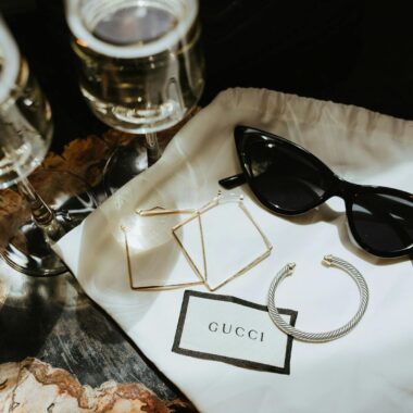 Elegant display of luxury Gucci accessories with champagne glasses.